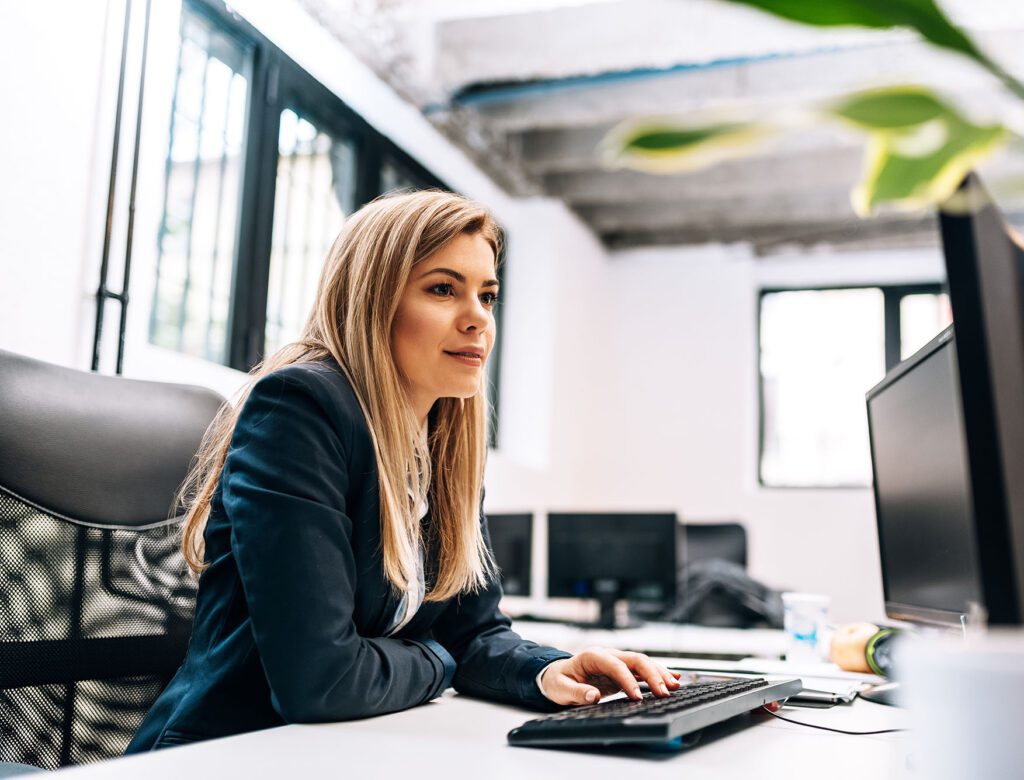 Close-up image of a businesswoman working on the computer.