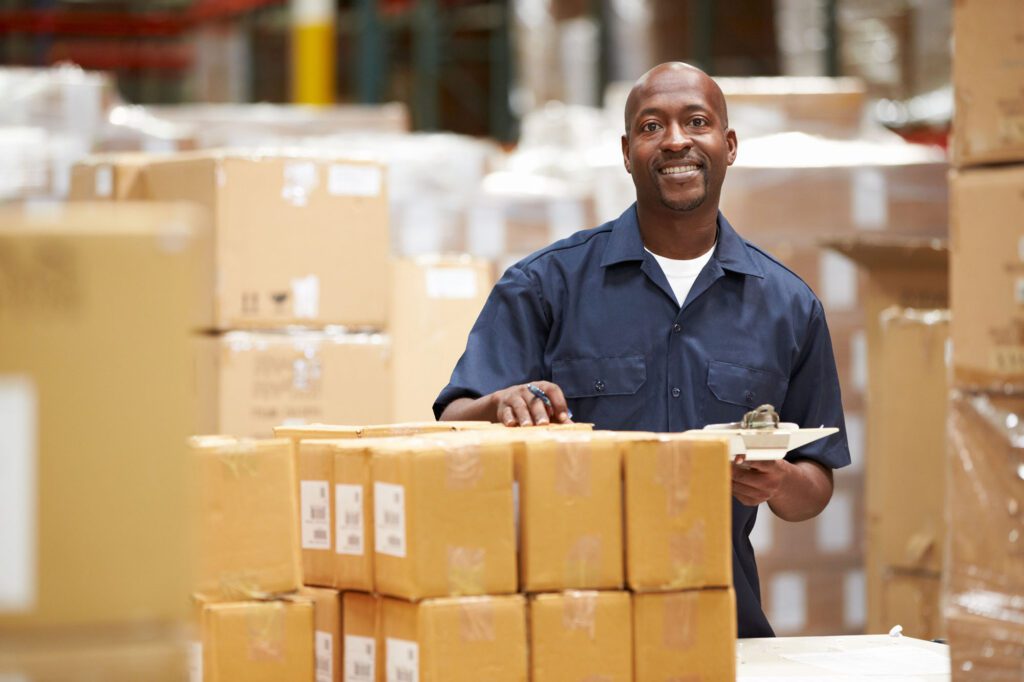 A worker in a warehouse preparing goods for delivery