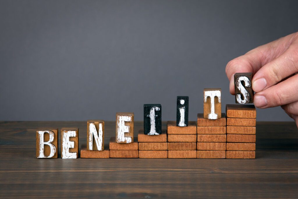 BENEFITS concept. Wooden alphabet letters on steps