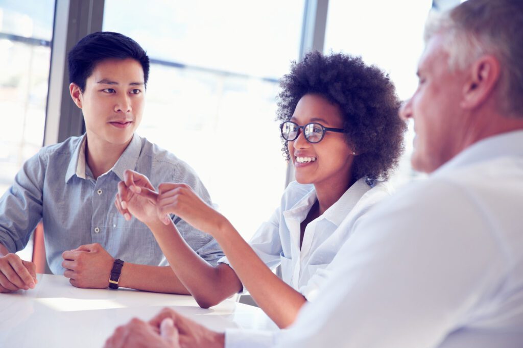 Three business professionals working and sharing ideas