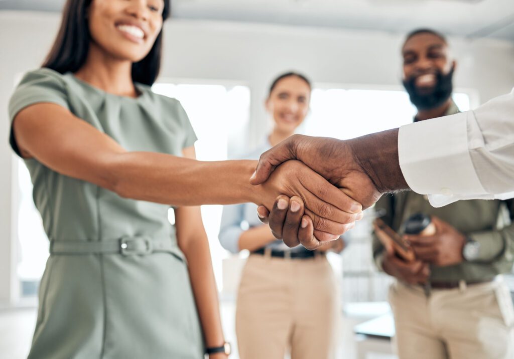 Handshake, teamwork and collaboration with the hands of business people in agreement, deal or thank you in an office at work. Meeting, partnership and welcome with an employee and partner at work