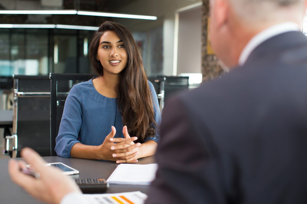 Smiling female client talking to male manager