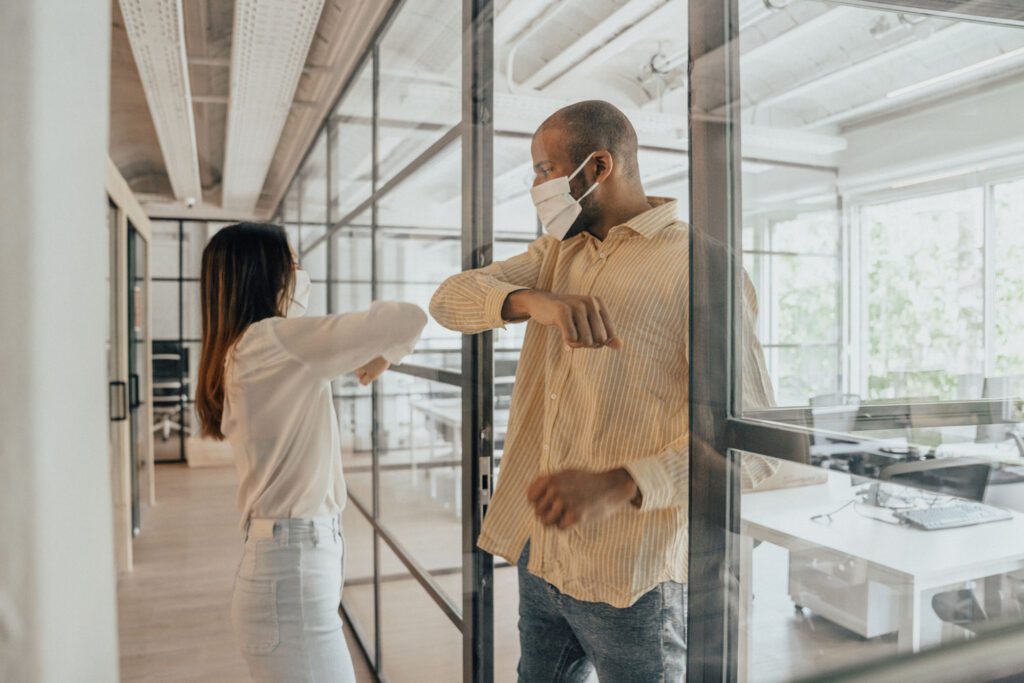 Colleagues doing alternative greeting during COVID-19