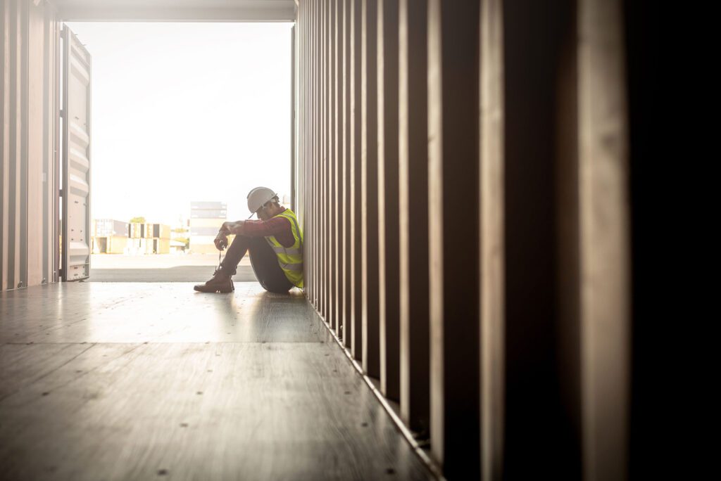 despair staff in logistic business sittng in container