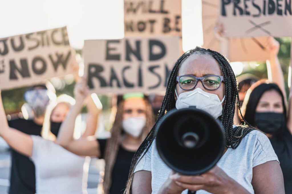 Group of demonstrators on road from different cultures protest for equal rights – Focus on african senior woman