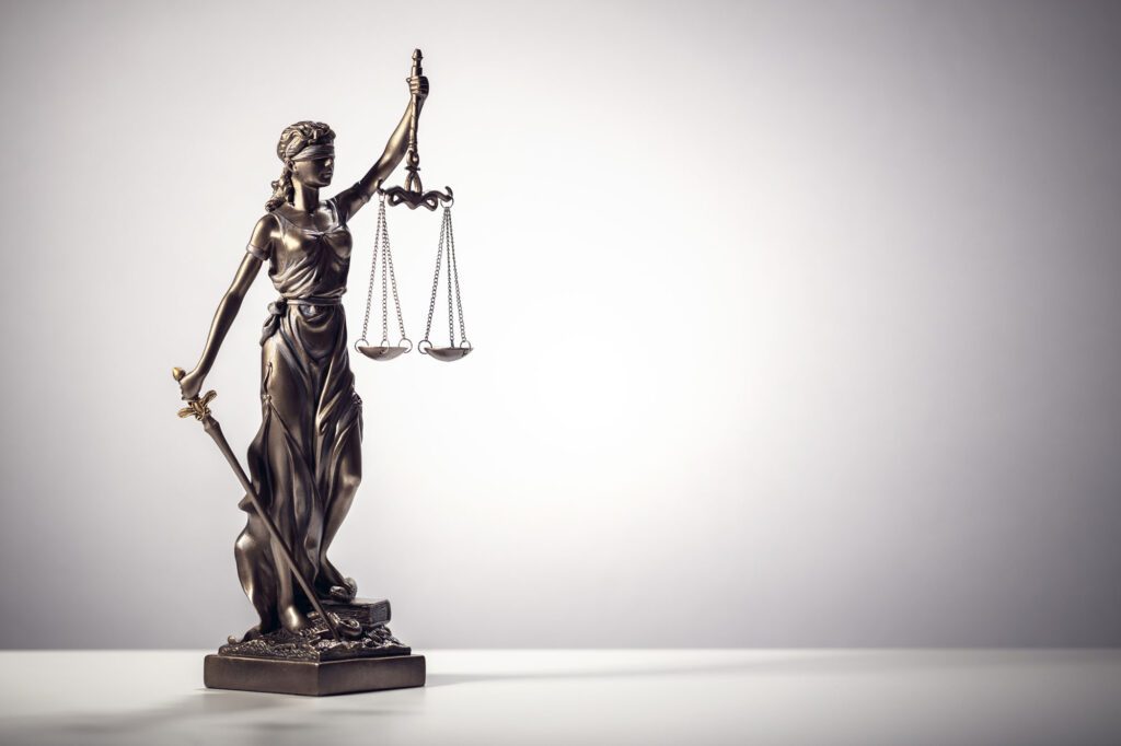 Legal and law concept statue of Lady Justice with scales of justice background