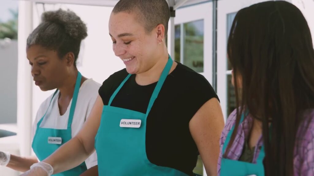 Photo of several volunteers serving food outdoors
